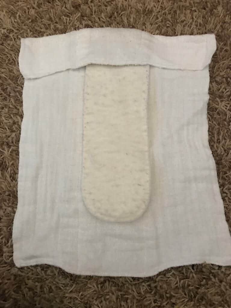 Fold top of diaper inward